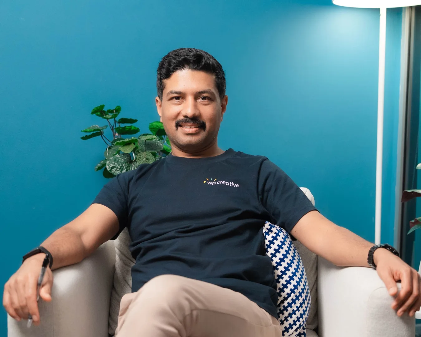 Nirmal Gyanwali relaxed in an armchair in a podcast studio