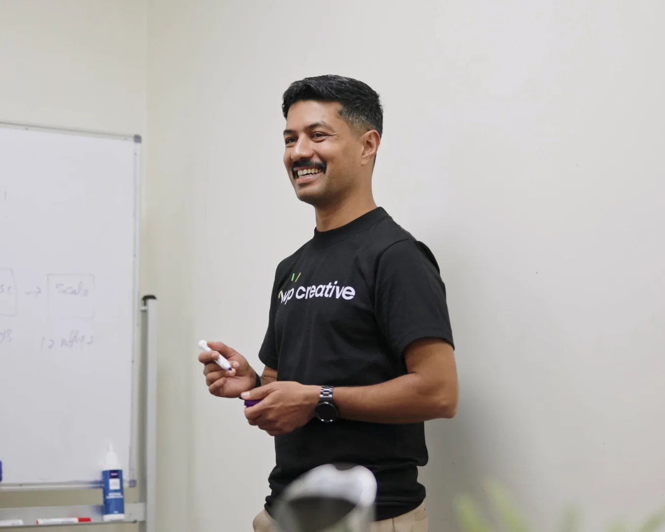 Nirmal Gyanwali presenting at a whiteboard during a workshop