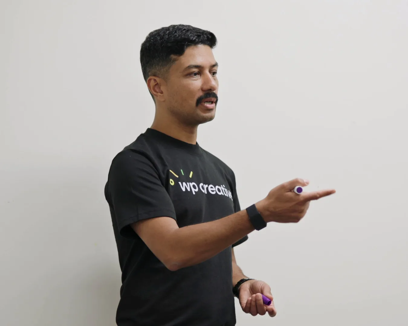 Nirmal Gyanwali explaining a website plan at a whiteboard