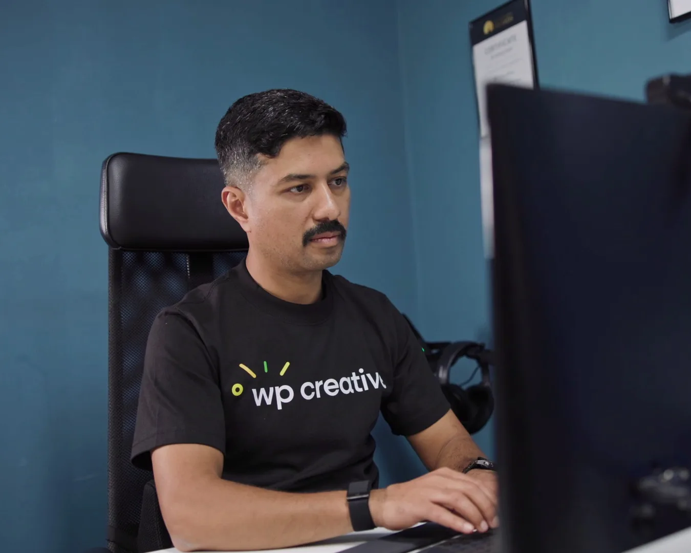 Nirmal Gyanwali working at his monitor in the WP Creative office