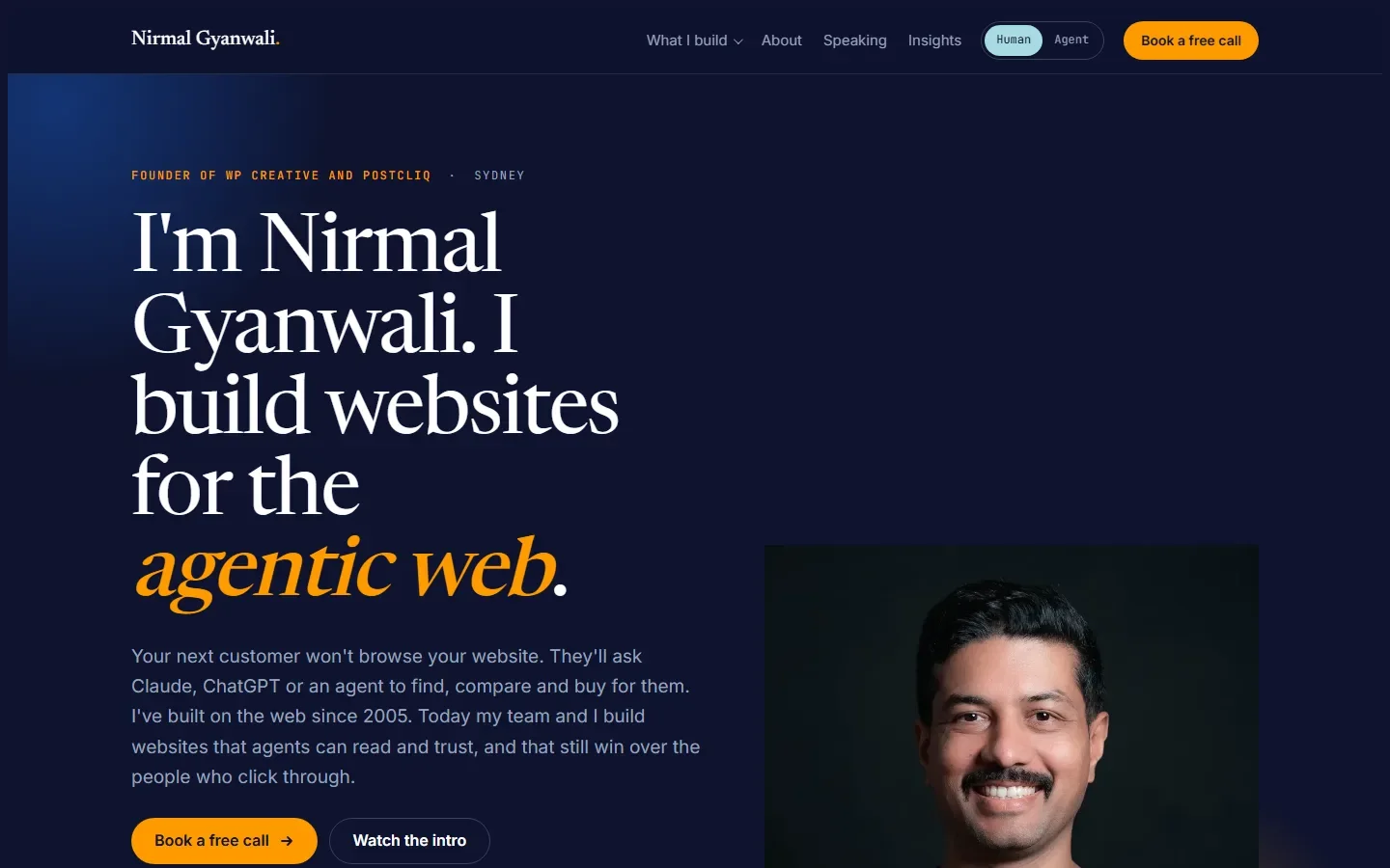 Third AI homepage attempt with Nirmal's photo and a guessed brand: a navy page, a large serif headline "I'm Nirmal Gyanwali. I build websites for the agentic web", and the portrait in the lower corner.